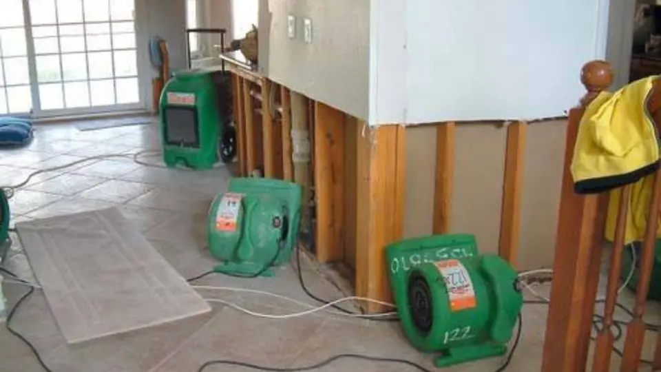 Walls opened to the studs with drying fans in place